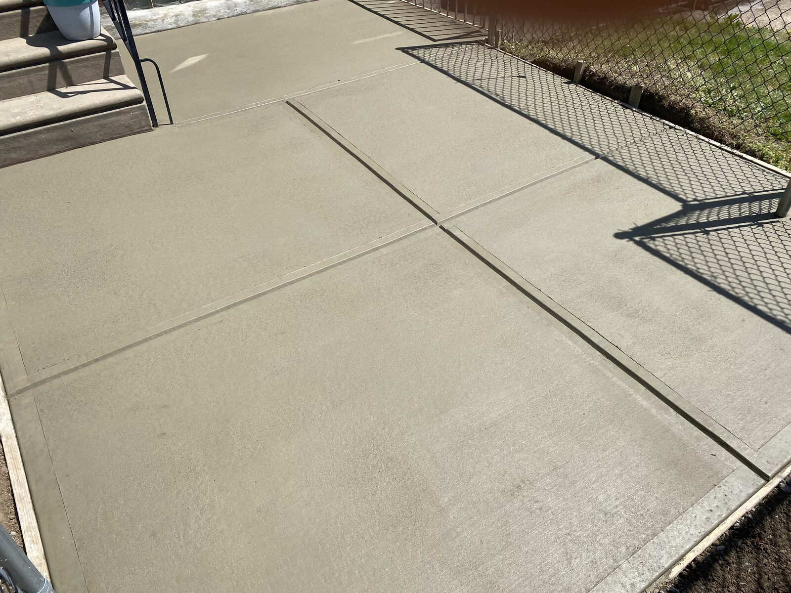 Freshly poured concrete pad with tooled joints