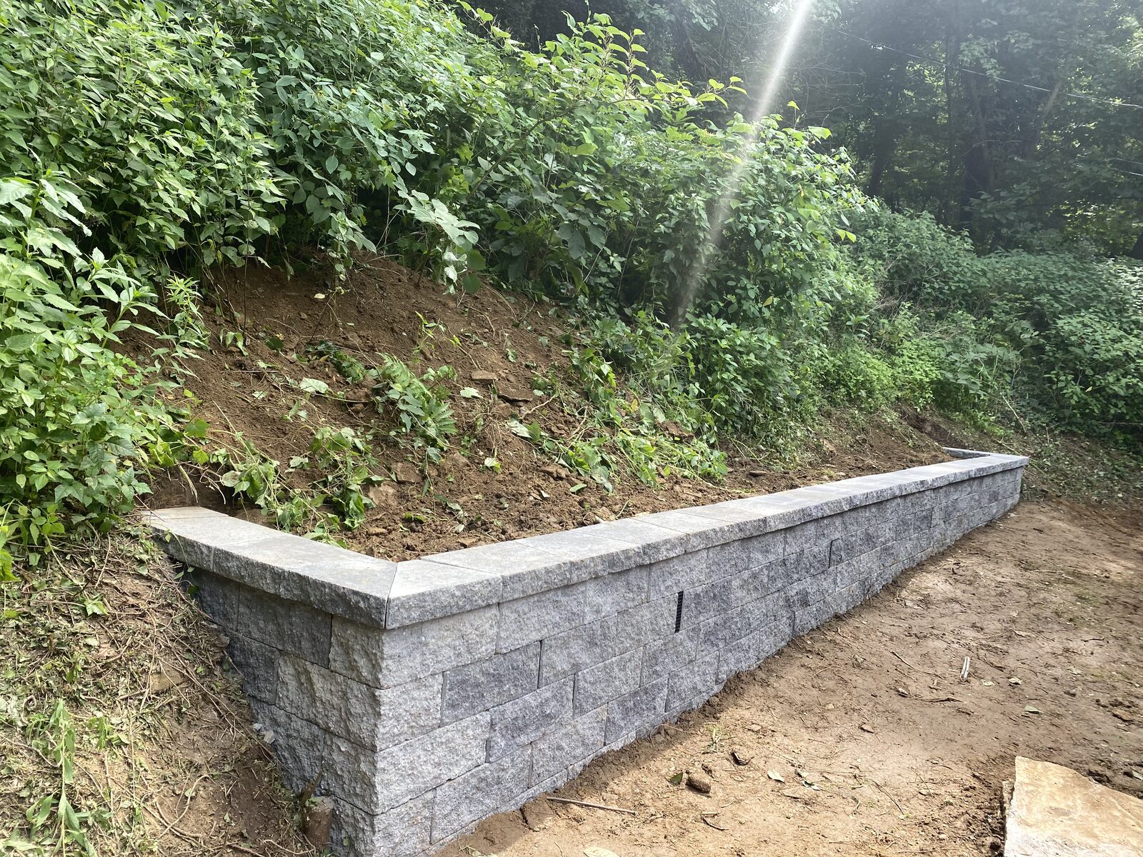 Stacked-block retaining wall on hillside