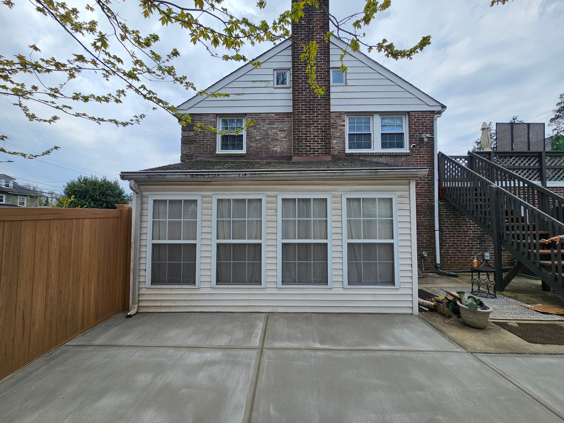 Smooth concrete patio behind brick home